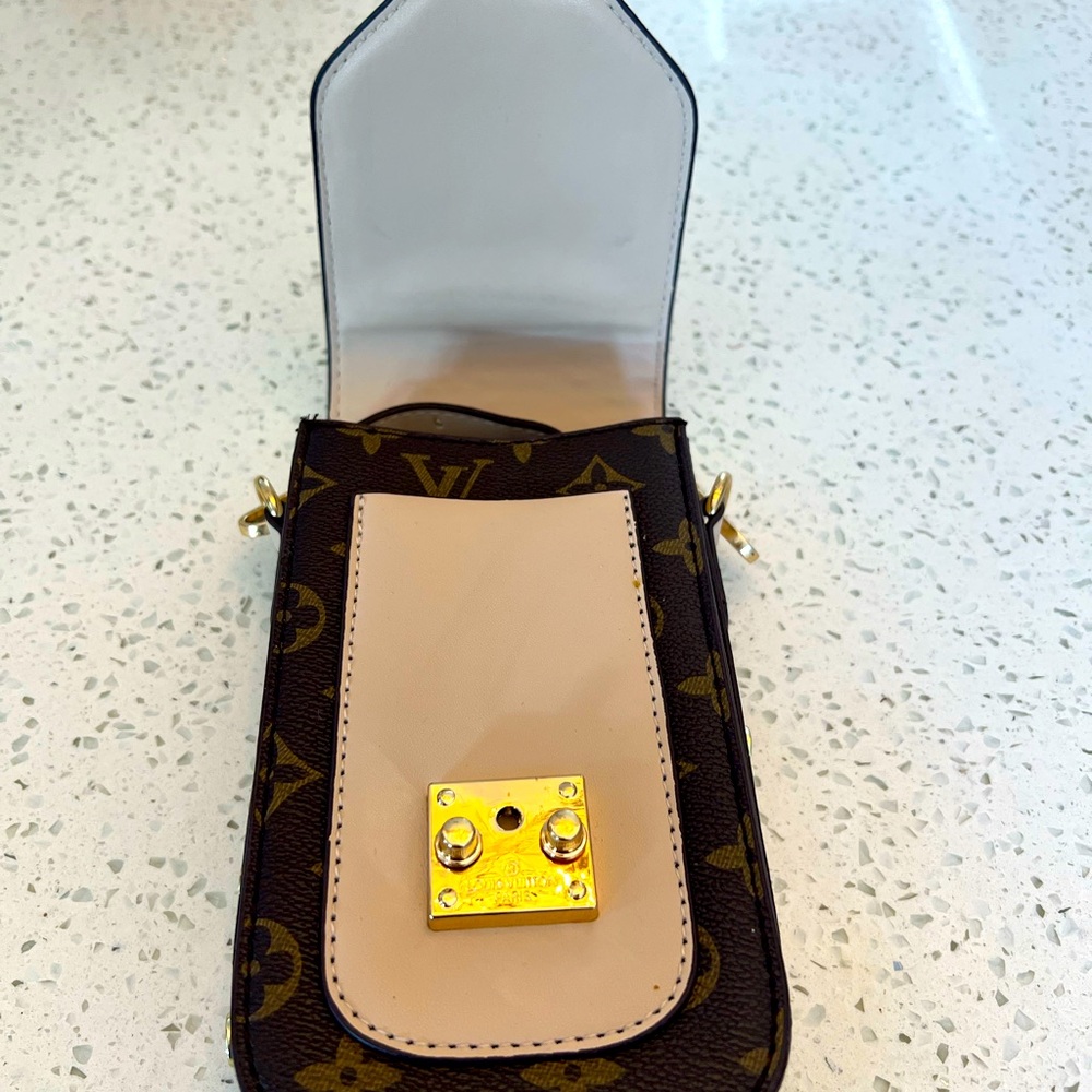 Monogram Canvas and Leather:LV Crossbody Phone Bag is durable with a lux feel.